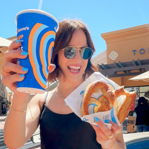 woman with pretzel and drink