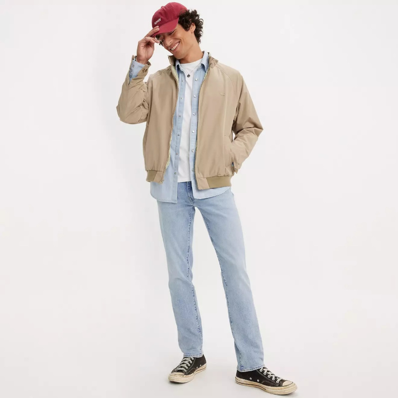 man in jeans wearing cap