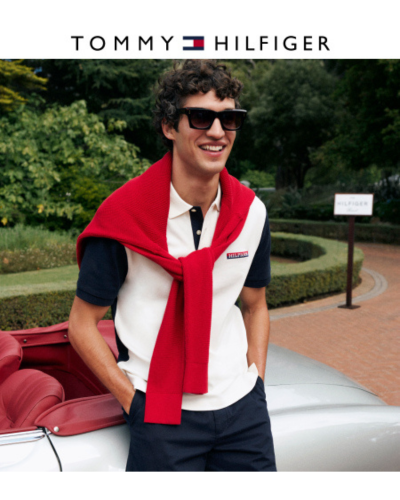 man in white and blue polo with red sweater