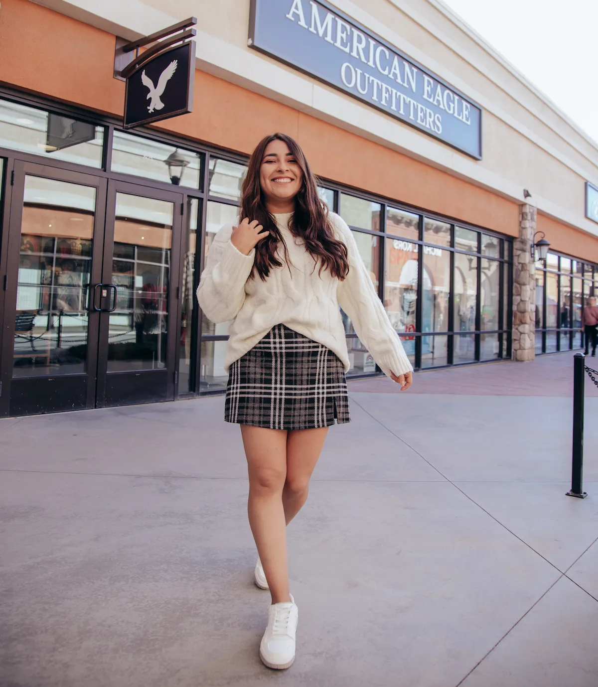 Woman Smiling Wearing In Front of American Eagle Outfitter Store