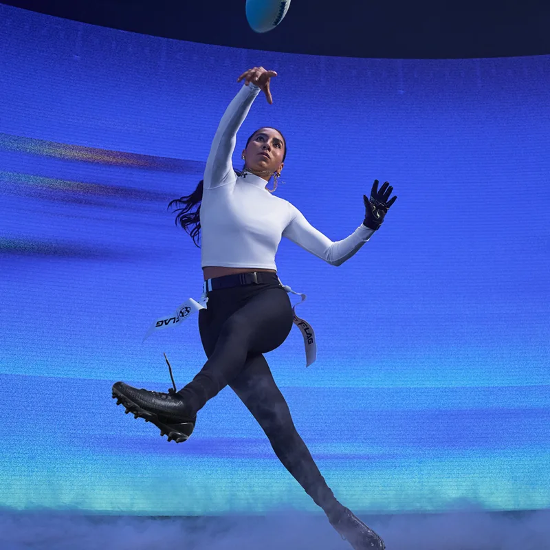 Lady jumping wearing Under Armour apparel - Square Photo