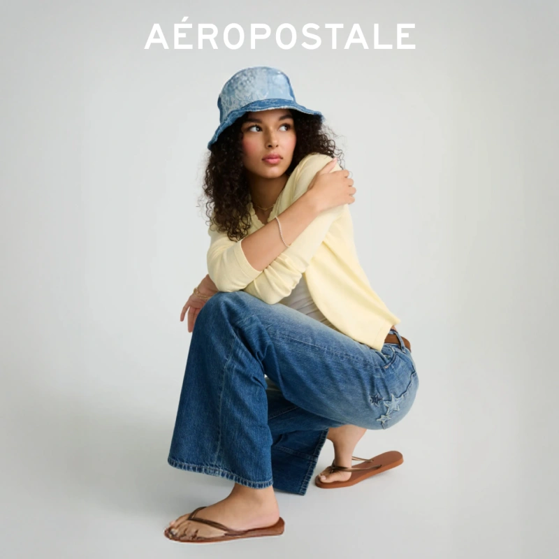 Woman kneeling down posing wearing a bucket hat