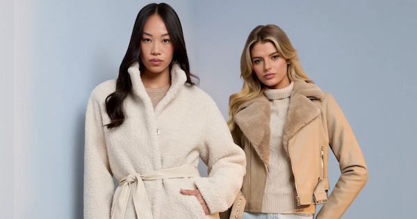 Two women wearing Guess factory winter clothes standing side by side