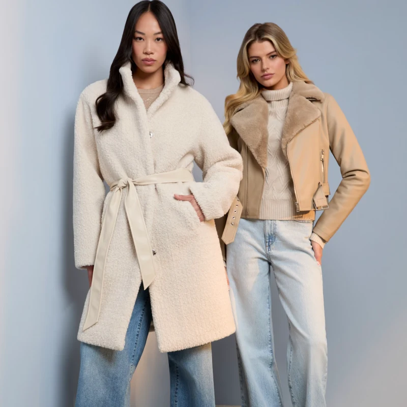 Two women wearing Guess factory winter clothes posing