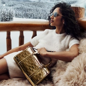 Woman with sunglasses holding Michael Kors bag