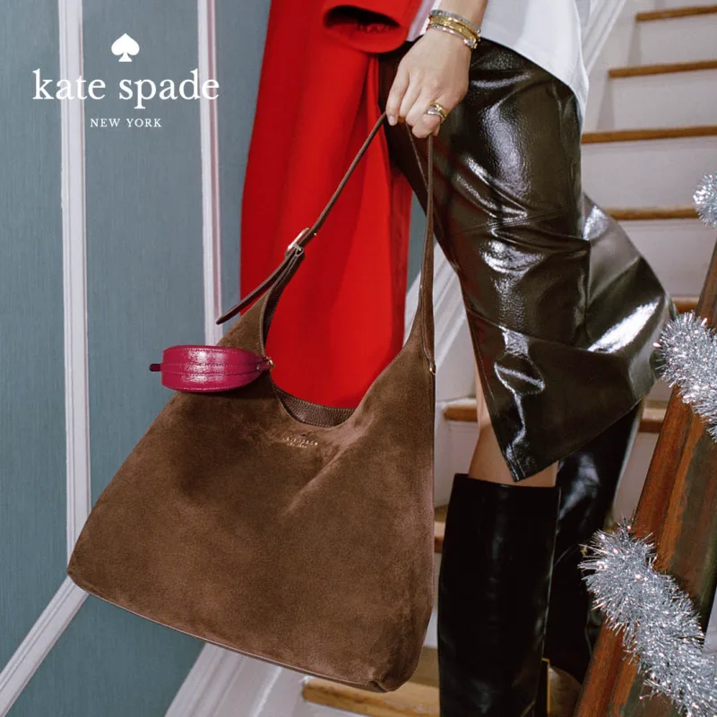 Woman going up stairs wearing Kate Spade clothes