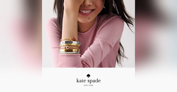 Girl smiling and showing Kate Spade bracelets on her arm
