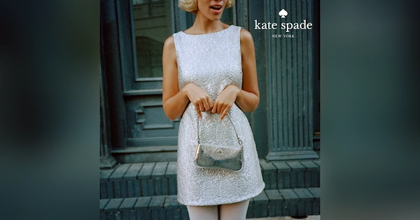 woman holding kate spade handbag with both hands