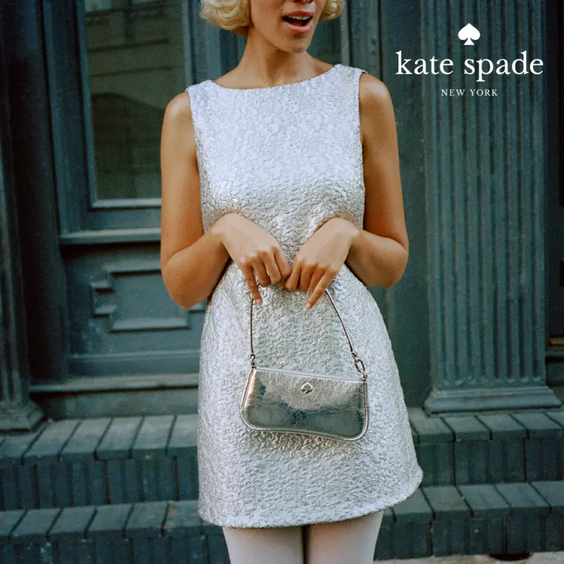 Woman in white dress holding kate spade hand bag