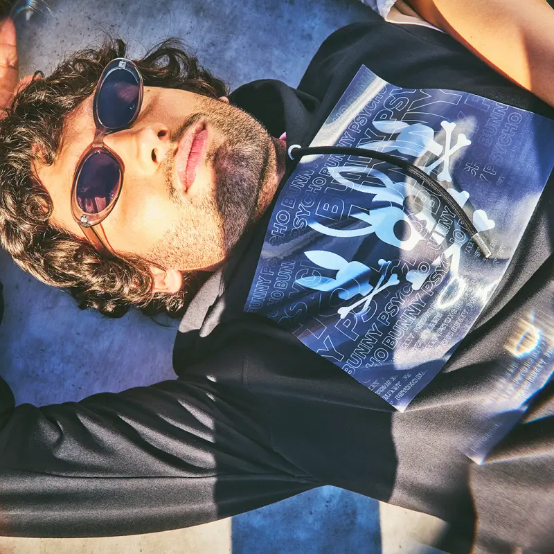 Man wearing shades and psycho bunny clothing selfie