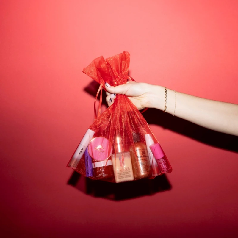 Woman holding a bag of makeup products