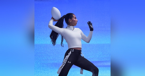Woman throwing a white football