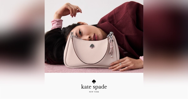 Kate Spade handbag in front of woman laying down