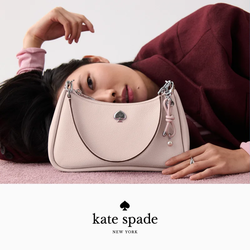 Woman laying next to Kate Spade handbag