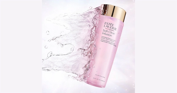 Water splashing on pink bottle beauty product