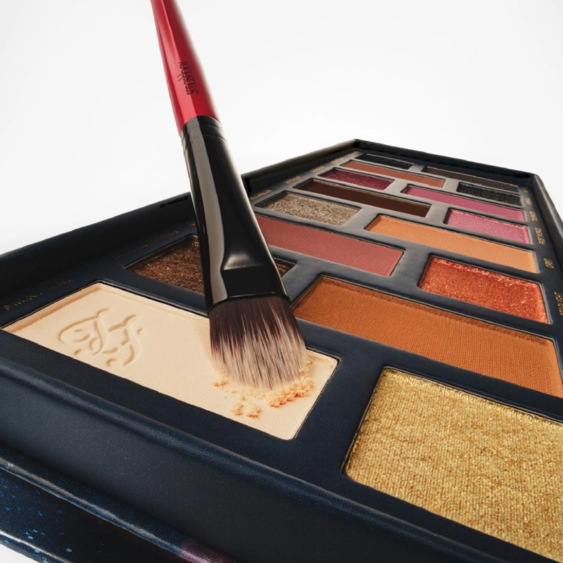 Red make up brush on make up pallet