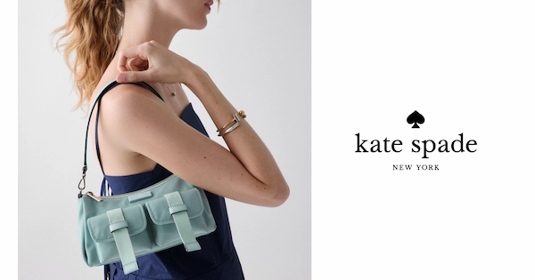 Redheaded woman wearing handbag from Kate Spade