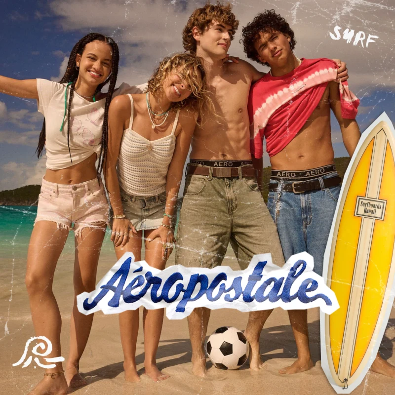 Young men and women on the beach with surf board