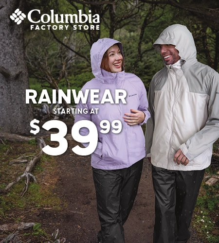 Couple hiking in the woods wearing Columbia jackets