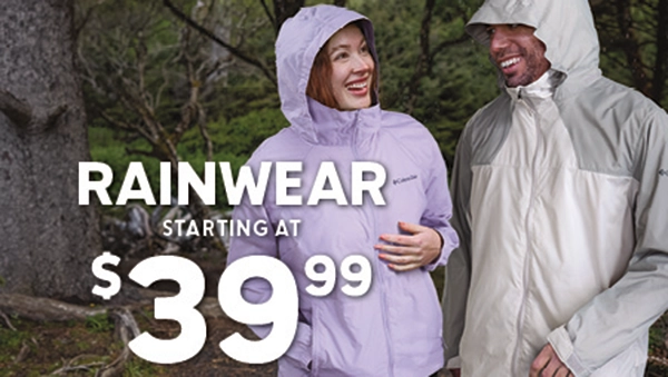 Couple hiking in the woods wearing Columbia jackets