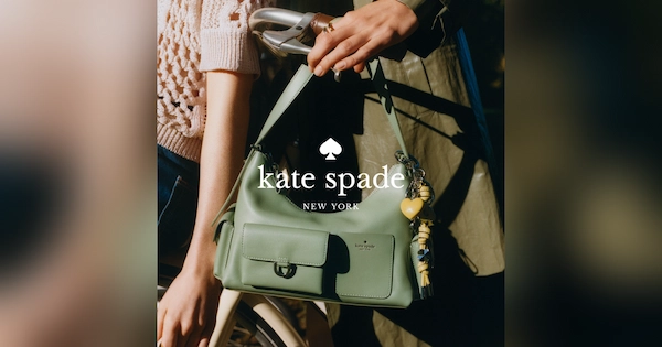 Woman holding a green Kate Spade handbag