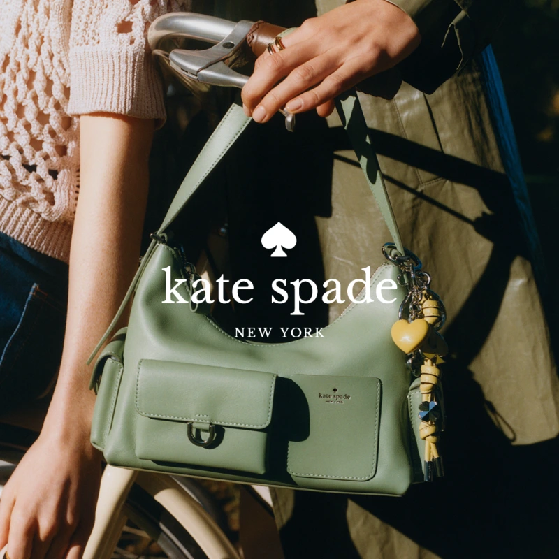 Home holding a green Kate Spade bag