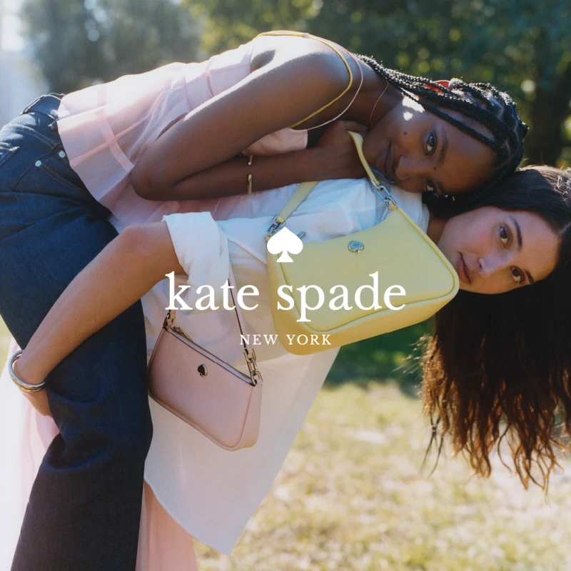 Woman with Kate Spade handbag  carrying another woman on her back