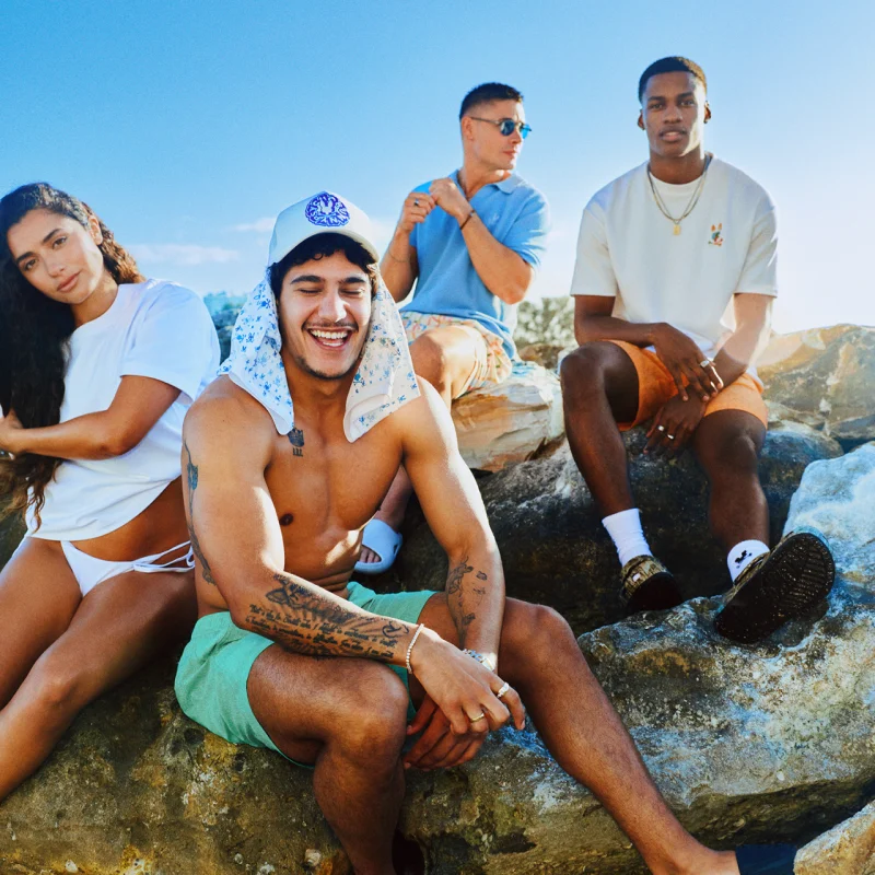 Young people on boulder wearing Psycho Bunny gear