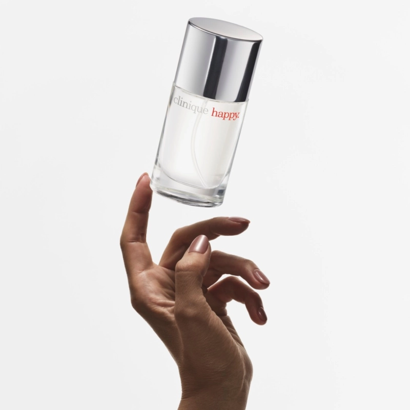 Hand touching a fragrance bottle floating