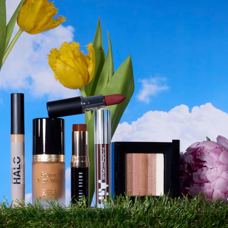 Make up accessories on green grass and blue sky