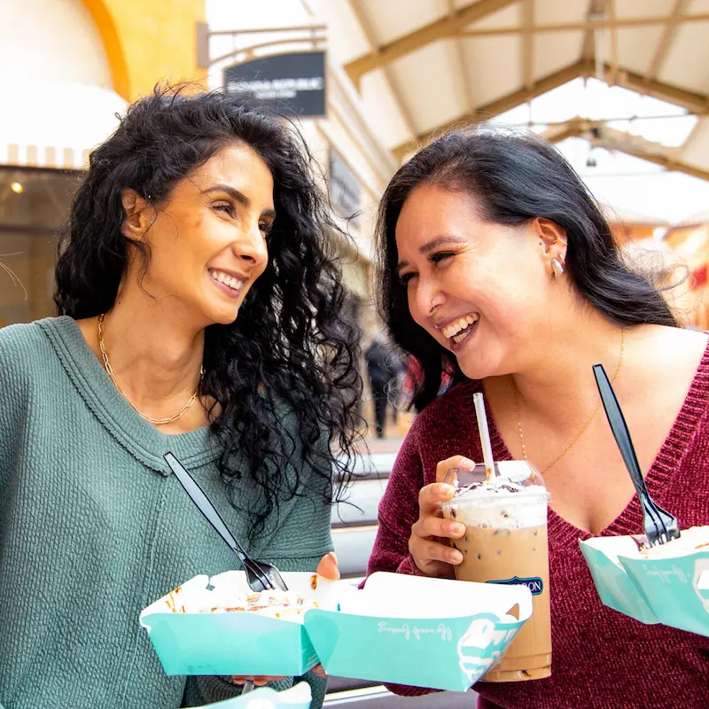 Two women eating at Tejon Outlets