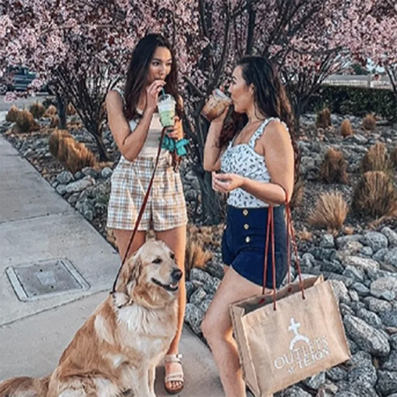 Women with golden retriever shopping at Tejon Outlets