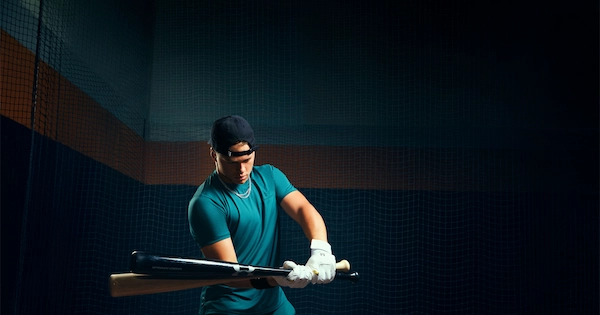 You man holding 2 baseball bats