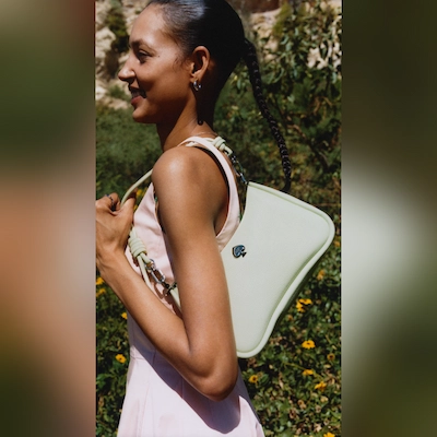 Women with pink dress and white late spade bag