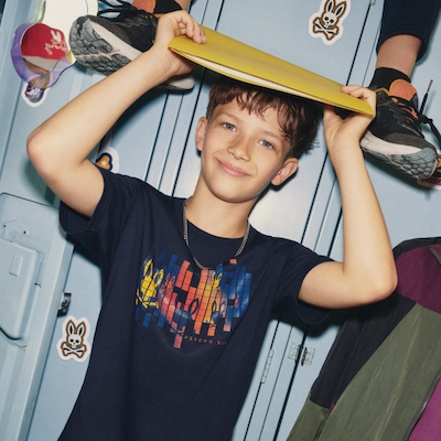Teenager wearing Psycho Bunny clothes with school locker background