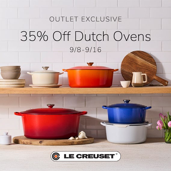 Different color dutch ovens on kitchen shelves