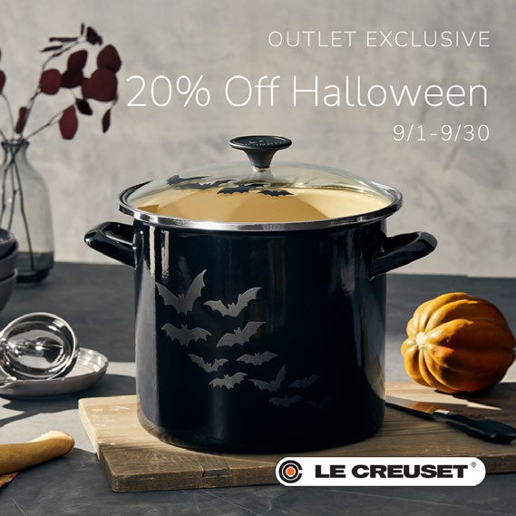 Black soup pot displayed stylishly on cutting board