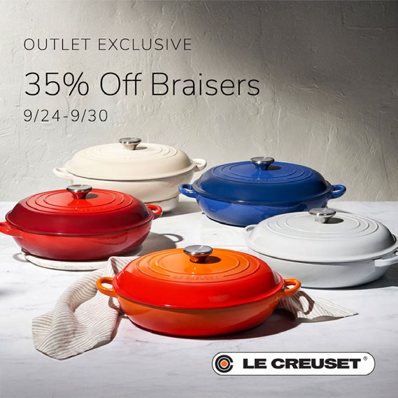 Different colored Le Creuset braisers displayed on counter top