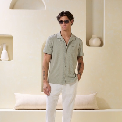 Man wearing sunglass and clothes from Guess Factory