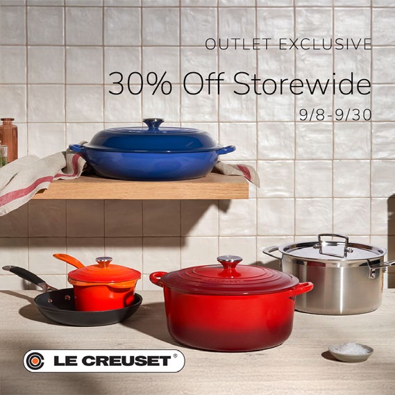Le Creuset pots on kitchen shelves