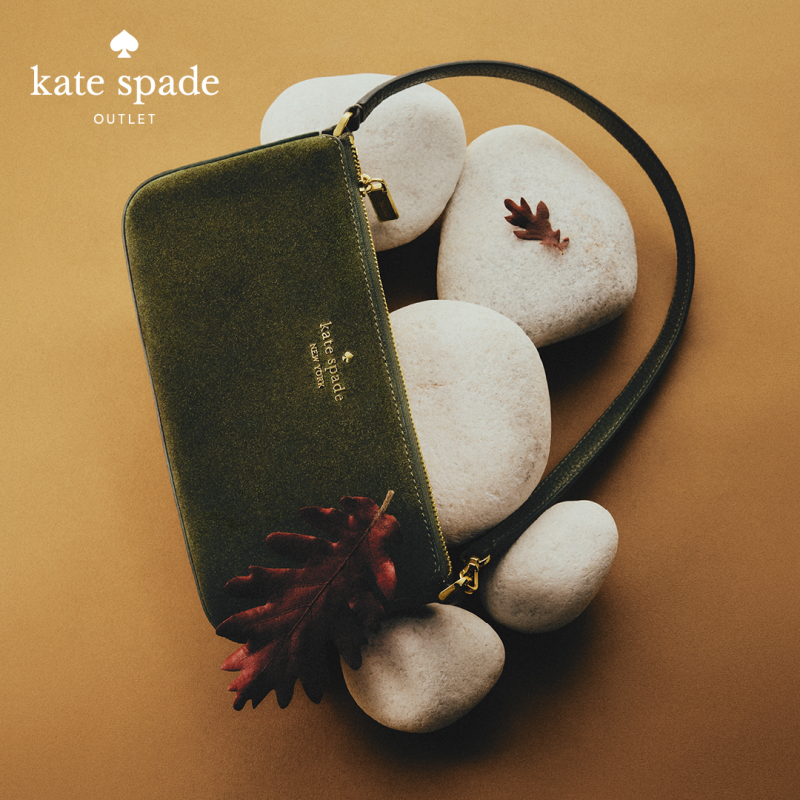 Kate Spade hand bag displayed stylishly on rocks