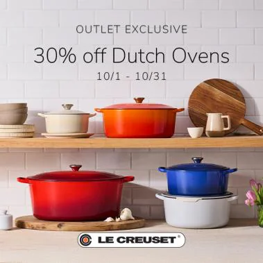 Le Creuset Dutch ovens in assorted colors on kitchen shelves