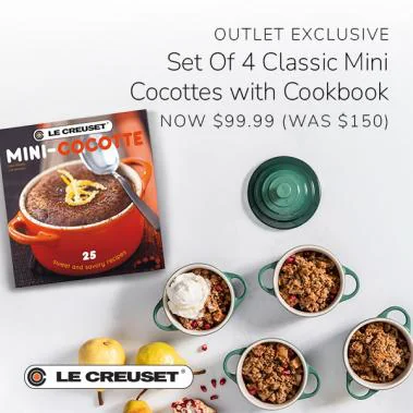 Green Le Creuset mini cocottes filled with crumble beside a cookbook