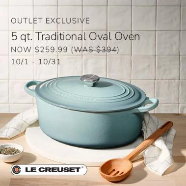 Light blue Le Creuset oval Dutch oven with a wooden spoon