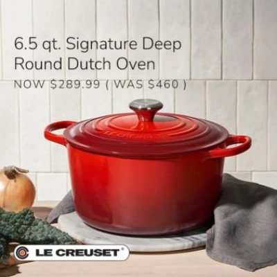 Red Le Creuset round Dutch oven on a marble trivet