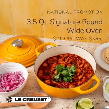 Yellow Le Creuset round wide oven filled with stew