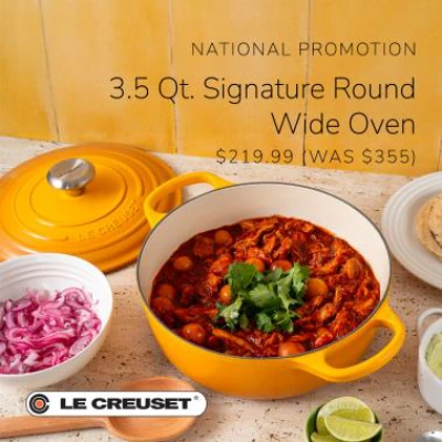Yellow Le Creuset round wide oven filled with stew